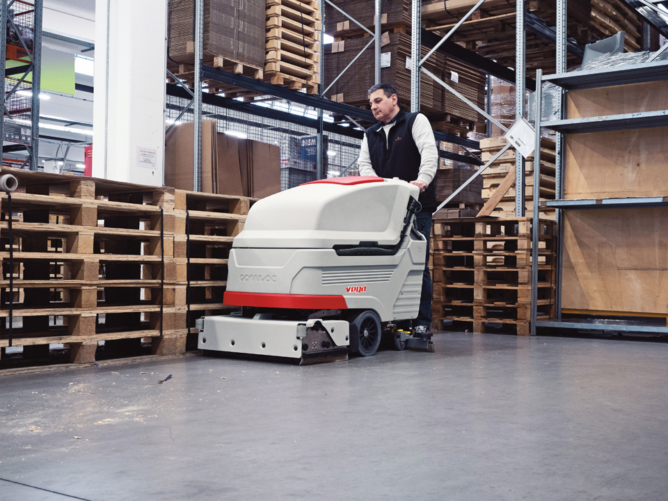 Comac Vega floor scrubber for industrial cleaning of a warehouse